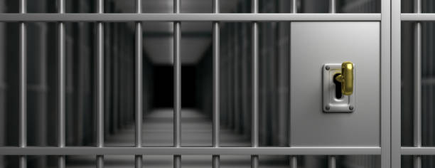 istock Prison interior. Jail cells and shadows, dark background. 3d illustration 1207905652