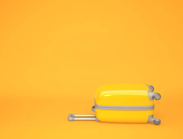istock Yellow travel suitcase on orange background 1207907388