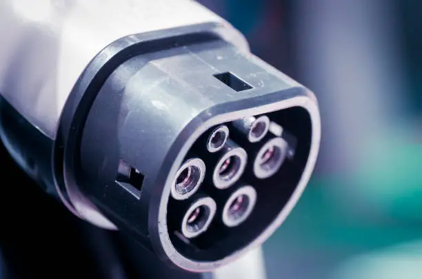 Macro photo of connector for charging electric car at IAA exhibition in Frankfurt am Main, Germany.