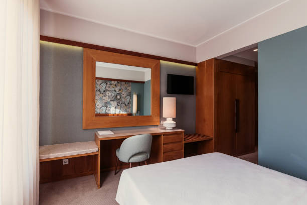 istock Small Hotel room interior with blue colours wall, wooden elements in design 1207908857