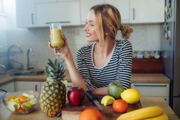 istock Happy smiling  healthy woman drinking smoothie 1207910908