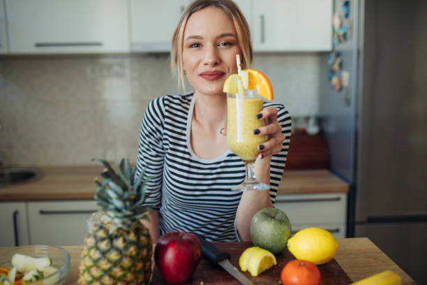 istock Happy smiling  healthy woman drinking smoothie 1207910993