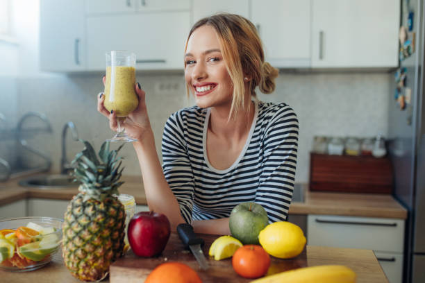 istock Happy smiling  healthy woman drinking smoothie 1207911033