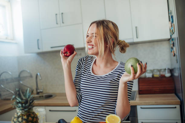 istock Young smiling woman with apple’s 1207912183