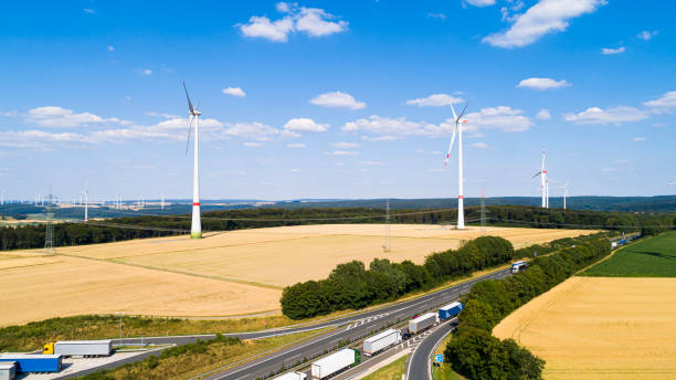 istock Aerial view of windmill against blue sky with clouds 1207917730