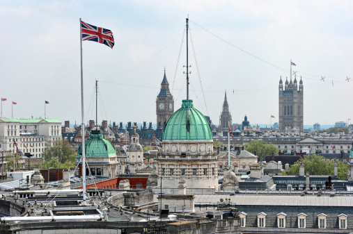Rooftop view over Whitehall, London, England, UK, with the roof of the Old Admirality Building in the centre.  The Union Jack is on top of Admiralty Arch.