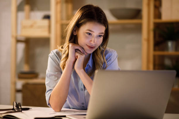istock Young woman doing finances at home using laptop 1207923310