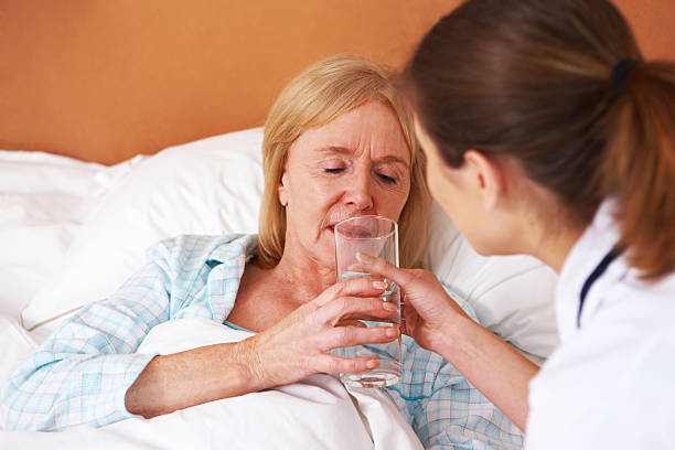 istock Nurse Tending to an Elderly Woman 120792376