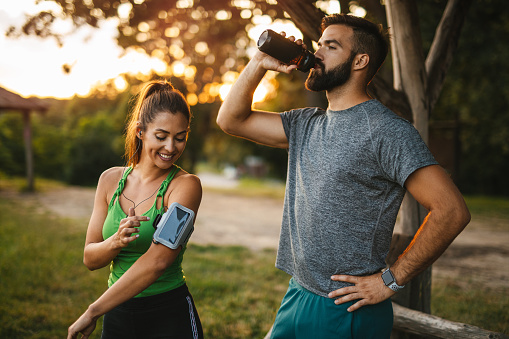 Young couple preparing for morning workout outdoors