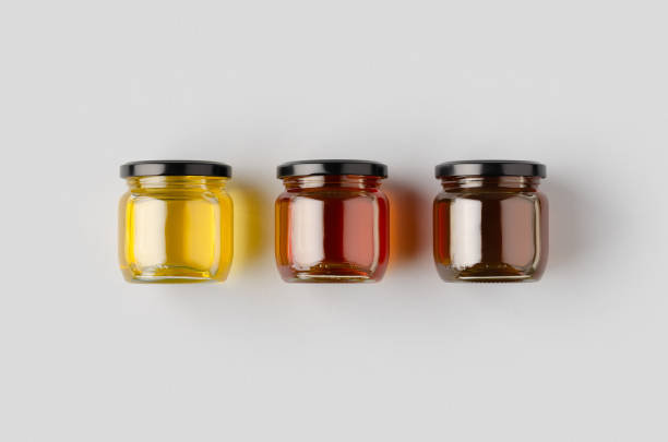 istock Honey jars mockup on a grey background. Three different colors. 1207926122