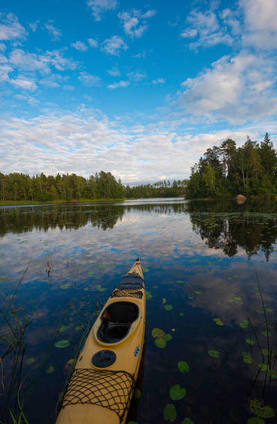 istock Reflections of canoe on calm lake 1207927263
