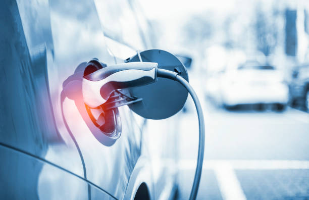 Electric Car Charging At Power Station Electric Car Charging At Power Station power cable photos stock pictures, royalty-free photos & images