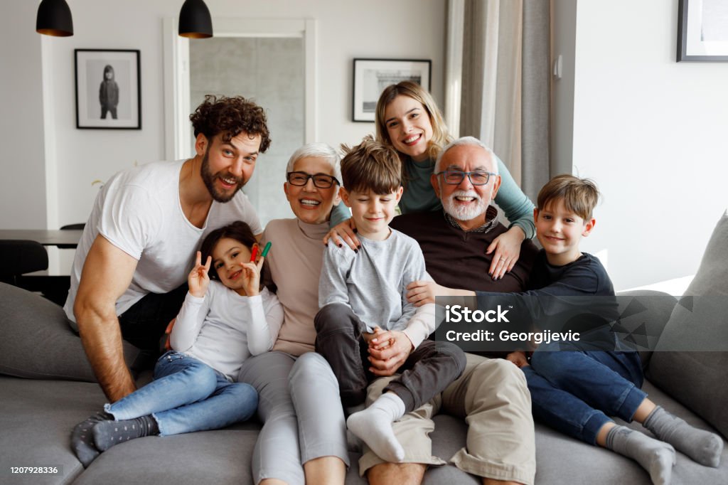 Big family Milti generational family is posing on the sofa in their living room. Family Stock Photo