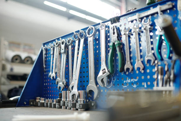 istock Kit of wrenches and other handtools for technical work hanging on hooks 1207928694