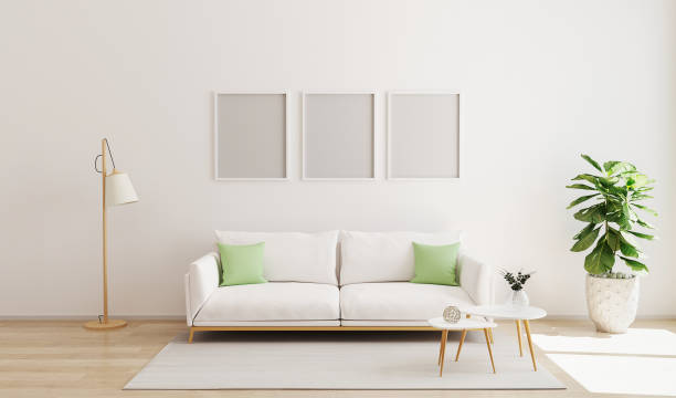 istock mock up three poster frame in modern interior background. Scandinavian style. Bright  and cozy living room interior background. Living room with white wall and sofa with contrast pillows. 3d render 1207929926