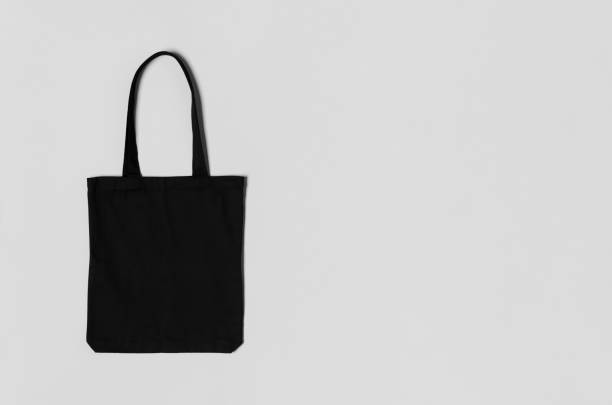 istock Black tote bag mockup on a grey background with copyspace. 1207930839