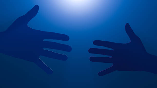 istock A hand reaches out to meet another hand. Night time. Blue background. 1207931062