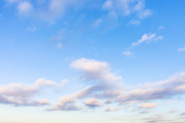 istock low white, gray and pink clouds in blue sky 1207935502