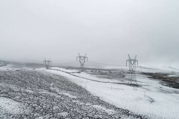 electricity pylon on mountain which covered with snow