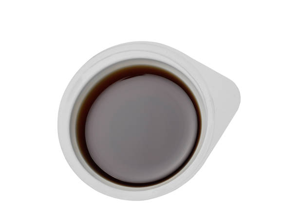 istock Disposable plastic container with soy sauce for food delivery. Isolated on a white background, top view 1207935691