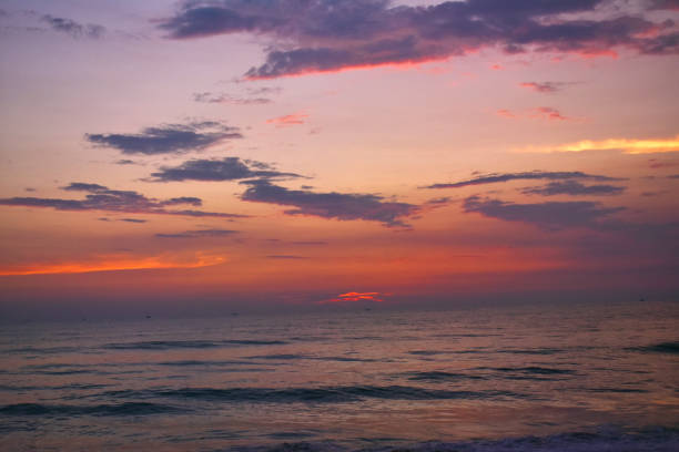istock beautiful sunset in the beach of goa with clouds 1207942368