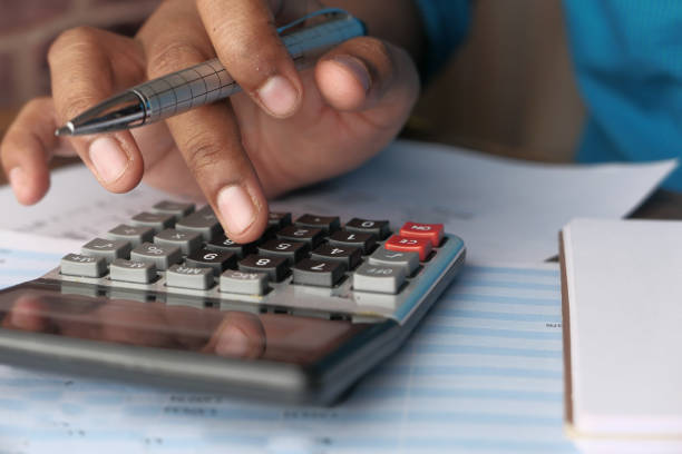 istock man hand use calculator on desk 1207943420