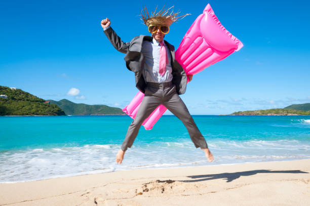 istock Businessman Jumping on the Beach 1207943731