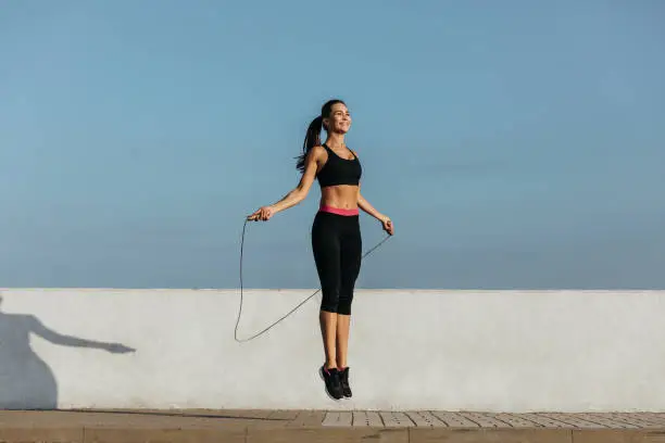 Young woman training with a jumping rope