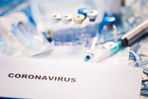 istock Coronavirus vaccine bottle blue medical background 1207944111
