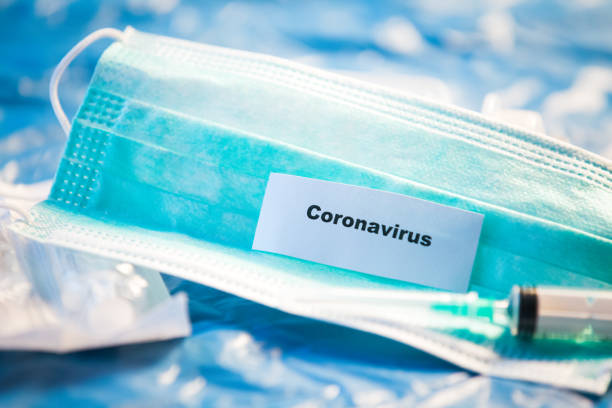 istock Coronavirus vaccine bottle blue medical background 1207944640