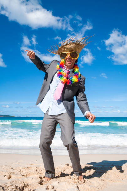 istock Happy Businessman Dancing on the Beach 1207945235