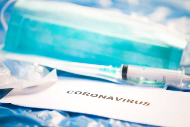 istock Coronavirus vaccine bottle blue medical background 1207945272