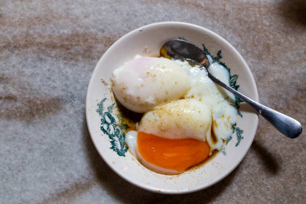 Half boiled eggs, nutritious and popular Chinese style breakfast in Malaysia Half boiled organic eggs, popular and nutritious Chinese style breakfast in Malaysia kopitiam. Low key lighting. kopitiam egg stock pictures, royalty-free photos & images