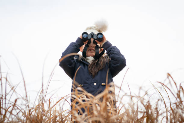 istock Girl looking far away with binoculars 1207946616