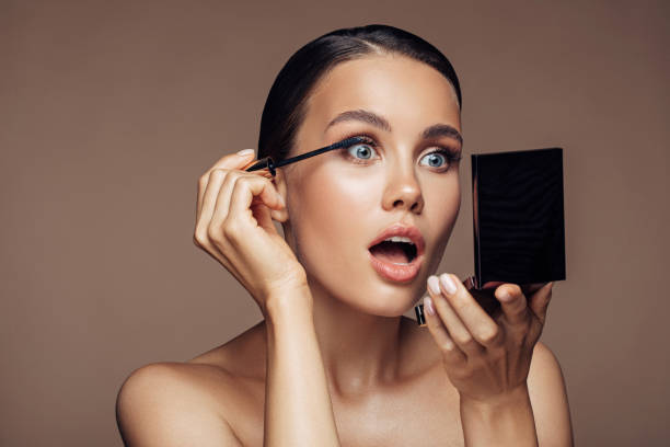 istock Woman applying make-up 1207949569