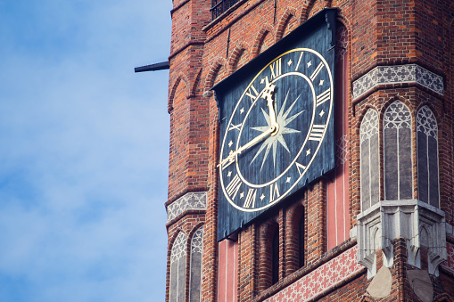 Closeup of a clock on a town hall tower, Torun, Poland
