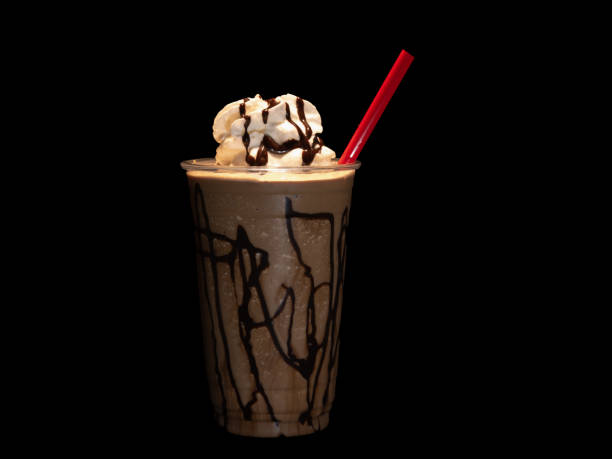 istock Chocolate smoothie or coffee frappe isolated on black with copy space 1207950011