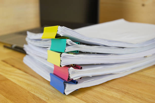 istock file folder and Stack of business report paper file on the table in a work office 1207950575