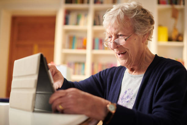 istock happy connected senior woman 1207951095