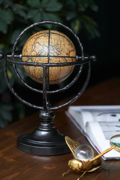 istock Education and travel concept with book, globe and magnifying glass 1207951219