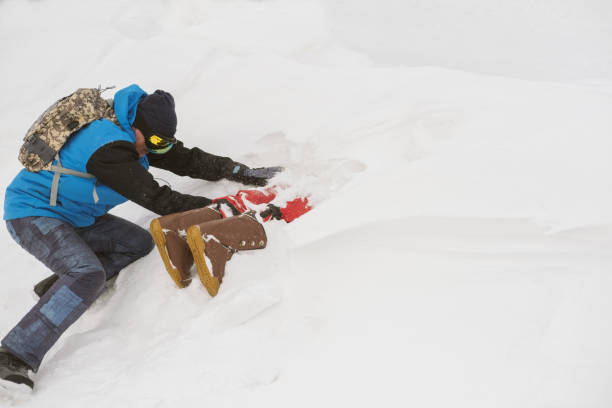 istock Freerider digging snow avalanche to safe a person buried by an avalanche. Danger extreme concept 1207952964