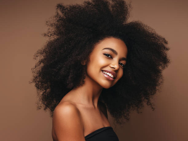 istock Beautiful smiling girl with curly hairstyle 1207955931