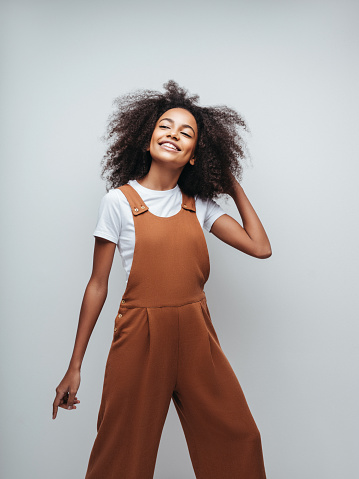 Beautiful smiling girl with curly hairstyle