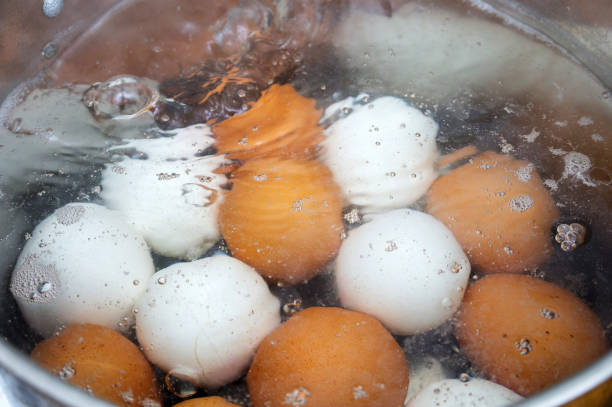 Eggs boiling in a pan of water. Selective focus.
