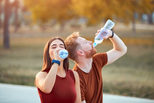istock Modern couple making pause in an urban park during jogging / exercise. 1207957188
