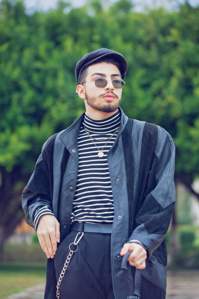 istock Young handsome man posing with a black umbrella. 1207964629