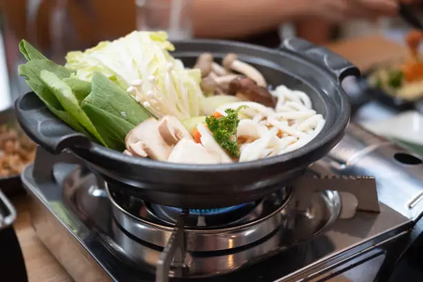 Japanese sukiyaki hot pot with vegetable, beef slice and udon noodles served in set