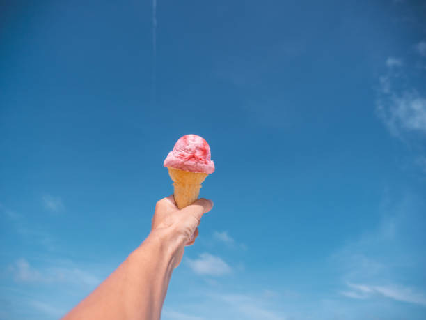 istock pov hand ice cream beach 1207967163