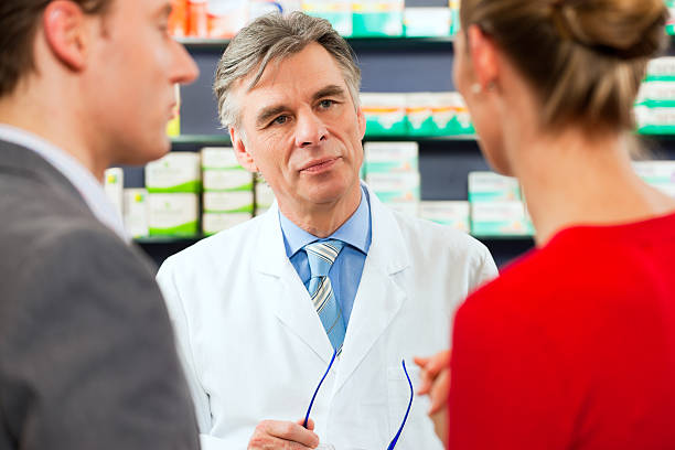 istock Pharmacist in front of supplies interacting with customers 120796804