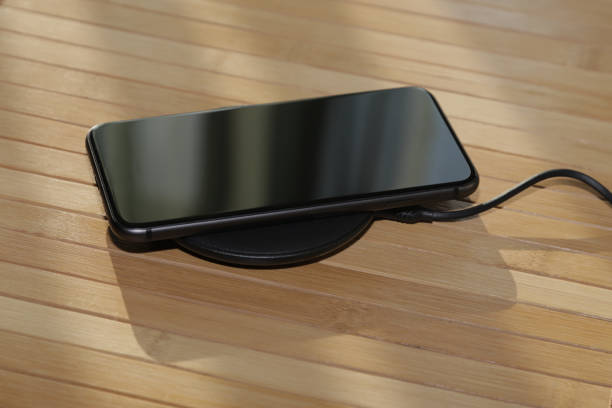 istock black phone on a wireless charge on the table 1207968094